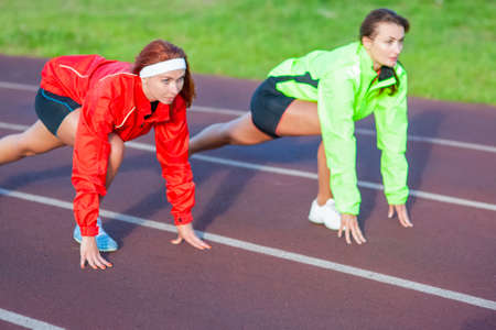 Two Caucasian Athletes Standing Prepared For Running on Track Course.Horizontal imageの写真素材