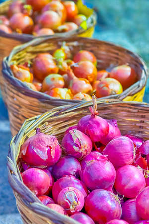 Baskets of Fresh Purple and Yellow Onions on Stand Prepared for Sale. Vertical Imageの写真素材