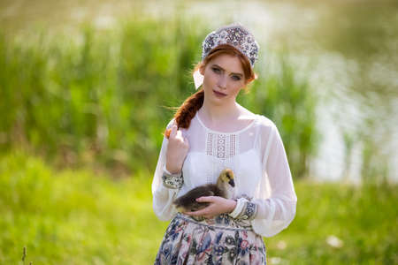 Cute and Sensual Fashion Portrait of Young Caucasian Female Posing With Duckling On Hand....