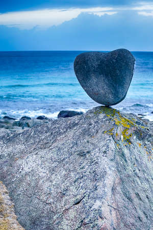 Hear Shaped Stone at Uttakliev Beach on Lofoten Islands in Norway. Vertical Image Compositionの写真素材