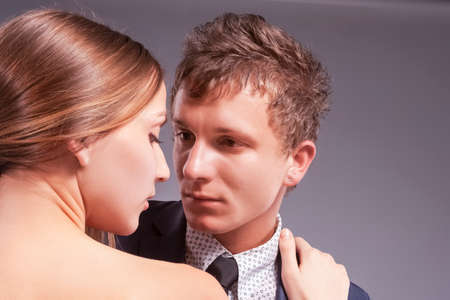 Loving Caucasian Couple Posing Together. Against Gray. Horizontal Image Composition