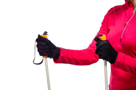 Closeup of Female Hands in Protective Gloves Holding Nordic Walking Sticks.Against White.Horizontal Image Compositionの写真素材