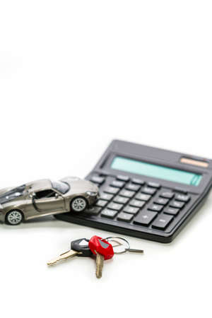 Financial Concepts of Car Loans and Credits. Composition of Scale Car and Keys against Calculator on Background. Vertical Orientationの写真素材