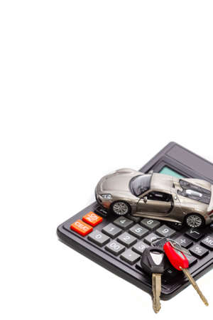 Ideas of Cars Loans and Credits. Composition of Scale Car and Keys against Calculator on Backgroundの写真素材
