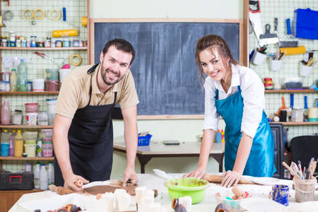 Pottering Concept. Two Happy Professional Ceramists or Claymakers During a Process of Clay...