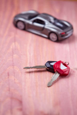 Car Loands and Credit Concepts. Car Symbol Along With bunch of Keys Against Vintage Wooden Background. Shallow depth of Field. Vertical Imageの写真素材