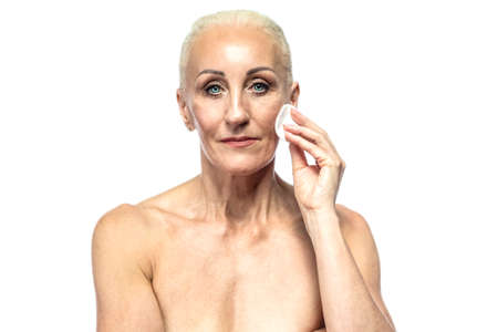 Senior Female People Concepts. Portrait Nude of  Senior Caucasian Woman Using Facial Cotton Pads ....