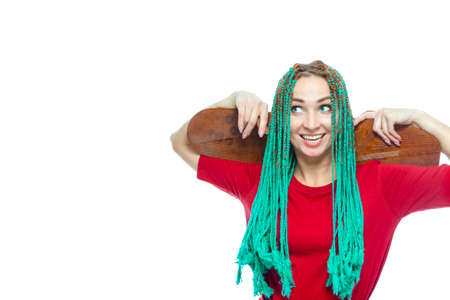 Portrait of Cute Caucasian Female with Green African American Dreadlocks Posing With Skateboard on...