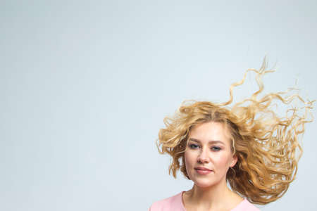 Portrait of Tranquil Caucasian Woman With Lifted Hair. Posing in Pink Blouse Against Gray. Horizontal Shotの写真素材