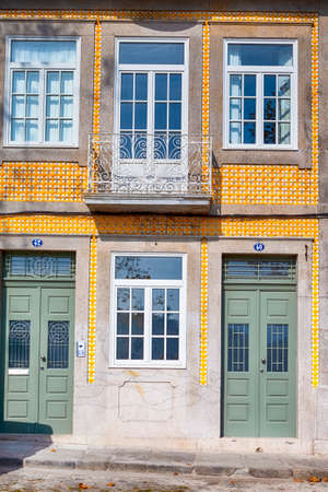 Travel Places Concepts. Unique Entrance Door with Traditional Azulejo Tiles in Porto, Portugal. Vertical Imageの写真素材