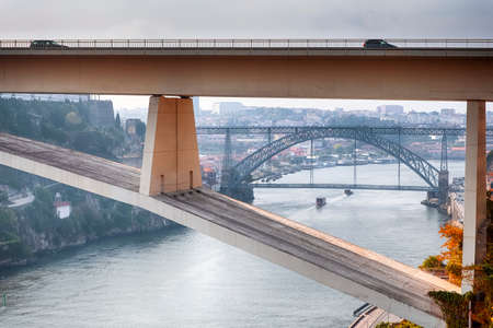 Travel Places Ideas. Line of Tourist Boats and Porto Cityscape at Daytime with Ponte Infante D Henrique in Background in Portugal. Horizontal Imageの写真素材
