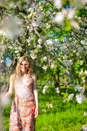 Summertime Concepts. Portrait of Positive Caucasian Woman In Garden Outdoors.Vertical imageの写真素材