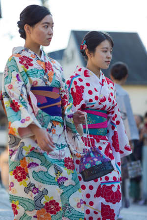 KYOTO, JAPAN - NOVEMBER, 8, 2019: Group of Young Japanese Girls Wearing Traditional Silk Geisha's Kimono Traveling on Street of Kyoto, Japan.のeditorial素材