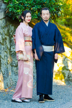 KYOTO, JAPAN - NOVEMBER, 8, 2019: Young Man and Woman Wearing Traditional Japanese Kimono Posing in Kyoto, Japan.のeditorial素材