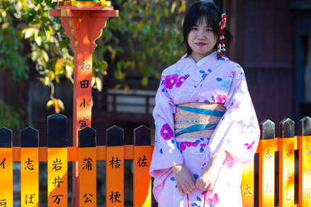 KYOTO, JAPAN - NOVEMBER, 8, 2019: Female Geisha Posing in Geisha's Kimono in Traditional Japanese Environment in Kyoto, Japan.のeditorial素材