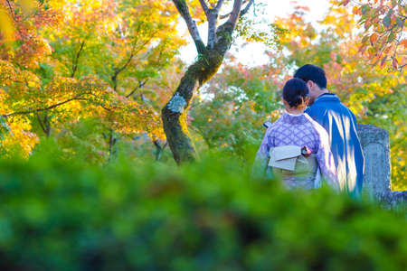 Japanese Destinations. Couple of Japanese Geishas in Traditional Silk Kimonos Posing in Garden of Kyoto City,  Japan. Horizontal Imageのeditorial素材