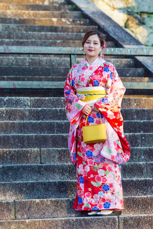 KYOTO, JAPAN - NOVEMBER, 8, 2019: Beautiful and Serene Japanese Lady Posing in Geisha Kimono On...