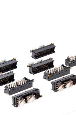 Electronic Components Concepts. Closeup of Rows of Long Angular PCB Connectors or Terminal Blocks Placed in Lines On White Background.Vertical Shotの写真素材