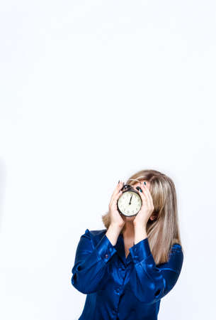 Time Ideas. Caucasian Blond Girl with Posing With Clock Against White. Holding Clock In Front of Her...