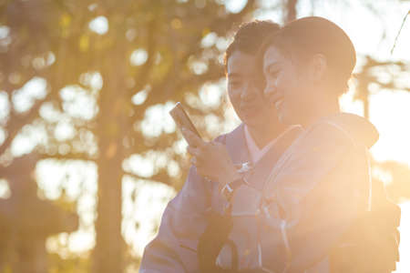 KYOTO, JAPAN - NOVEMBER, 8, 2019: Japanese Ladies Posing in Geisha Kimono and taking Pictures At One of the Kyoto Streets, Japan.のeditorial素材