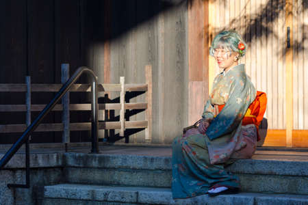 KYOTO, JAPAN - NOVEMBER, 8, 2019: Beautiful Japanese Geisha in Silk Kimono in Traditional...