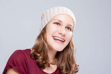 Teenage Ideas. Closeup Portrait of Positive Caucasian Teenager Girl Wearing Teeth Brackets. Posing...