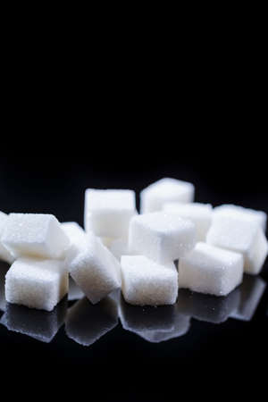 Closeup Macro Shoot of White Cube Sugar Placed Bulk Against Black Background. Horizontal Image...