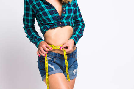 Healthy Lifestyle. Image of Body Parts of Caucasian Female Using Tape Measure for Body Control...