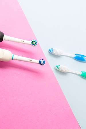 Oralcare Concepts. Pair of Electric and Manual Toothbrushes Together Over Black Background. Vertical...