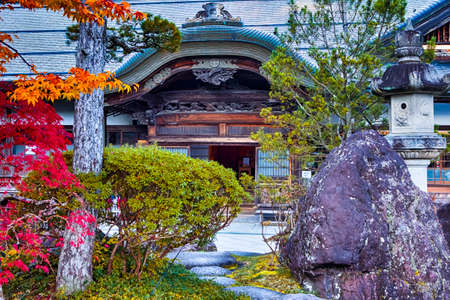 Japanese Traveling. Tradtional Shinto Shrine With Seasonal Red Maple Trees At Koyasan Mountain At Fall in Japan. Horizontal Imageのeditorial素材