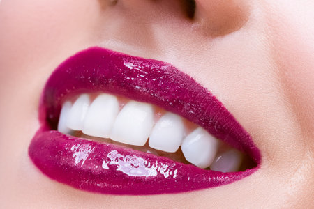 Closeup Beauty Portrait. Macro Closeup Shot of Smiling Female Vivid Purple Lips and Perfect White Teeth Isolated Over White. Horizontal Compositionの写真素材