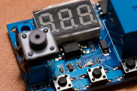 Macro Shot of Plugged-in Printed Circuit Board with Three Digits Display and Surface Mounted...