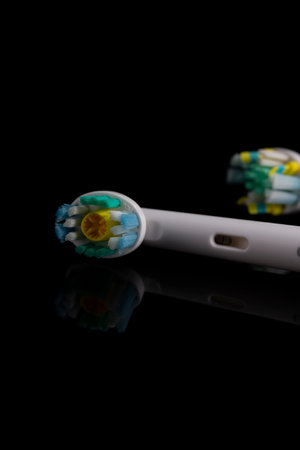 Oral Care Concepts. Closeup Image of Spare Attachments for Electric Toothbrush On Black Surface....