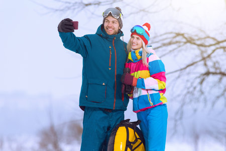Winter Sport and Activities. Portrait of Lovely Caucasian Couple Having Tube Activities In Winter...