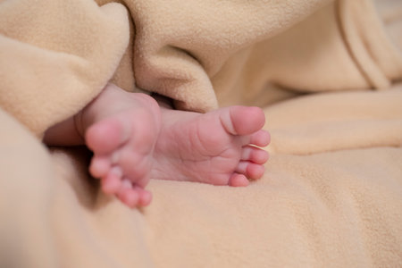 Newborns Concepts. Macro Closeup Shoot of a Four Week Old Baby Boy Feet Over  Light Brown Towel. Horizontal Image Compositionの写真素材
