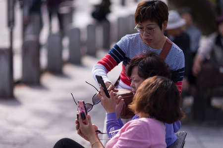 Kyoto, Japan - November 7, 2019: Group of Japanese Women With Smartphone Checking Route Together on Street of Kyoto in Japan, in November 7, 2019のeditorial素材