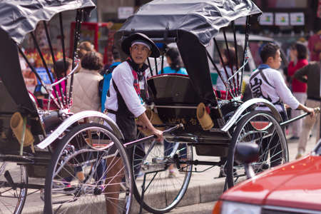 Kyoto, Japan - NOVEMBER 7, 2019: Japanese Trishaw in Traditional Japanese Working Outfit for Rickshaw on Street in Kyoto, Japan.のeditorial素材