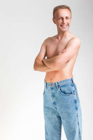 Natural Portarit of Smiling Caucasian Handsome Man Posing With Naked Torso On White Background. Vertical Imageの写真素材