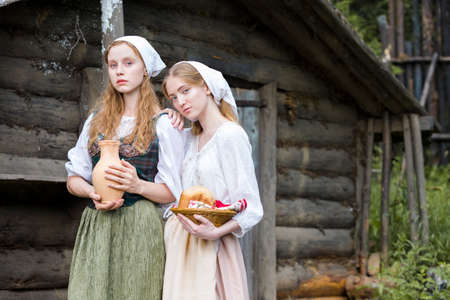 Rural Style Concepts. Two Young Beautful Caucasian Girlfriends in Traditional Rural Outfit  Posing...