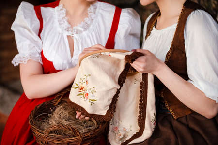 Closeup of hands of Two Caucasian Ladies  Posing With  Fancywork Hoop in Retro Dress In Rural...
