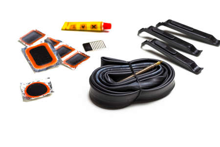 Road Cycling Concepts. Complete Set of Road Bike Inner Tube Repairing Kit Against White.Horizontal...