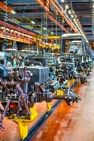 Heavy Industry Ideas. Modern Tractors Machinery Assembly Line With Manufacturing  Facilities Alongside. Vertical Image Compositionの写真素材
