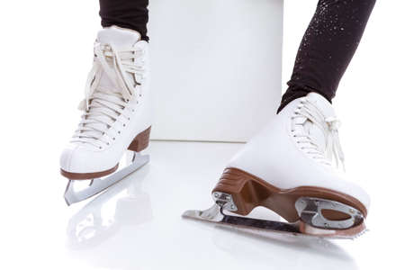 Closeup of Youth Female Ice Skates Boots Against White Background. Horizontal Imageの写真素材