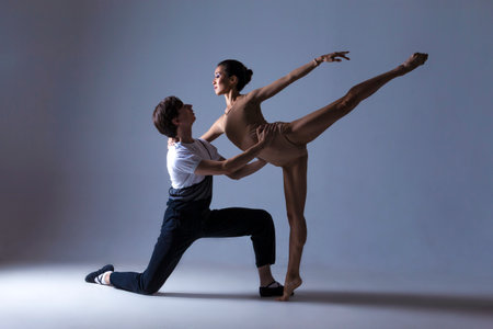 Dance Photography Ideas. Professional Ballet Dance Couple Performing Together in Studio While Girl...