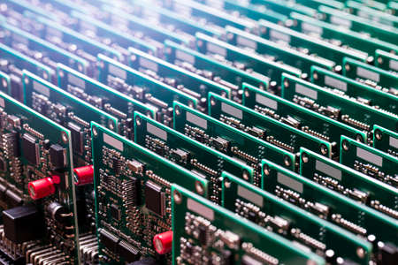 Closeup of Line of Ready Automotive Printed Circuit Boards with Surface Mounted Components With...
