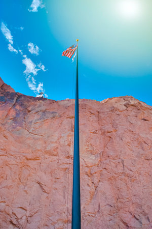 American Travel Destinations. National  American Flag on Pole Against Blue Sky in Arizona in The...