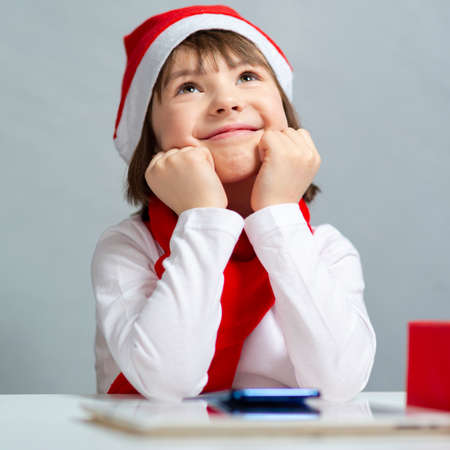 Caucasian Child Kid Girl Wearing Santa Hat Using Laptop for Online Christmas Gift or New Year...