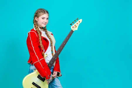 Portrait of Nice Her She Attractive And Cheerful While Excited Teen Girl Sitting in Chair With TV Remote Control Changing Programs Online Isolated on Turquoise Background.Horizontal imageの写真素材