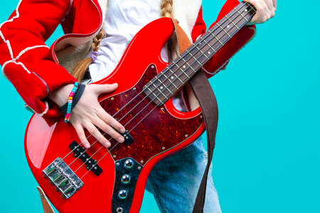Portrait of Nice Her She Attractive And Cheerful While Excited Teen Girl Sitting in Chair With TV Remote Control Changing Programs Online Isolated on Turquoise Background.Horizontal imageの写真素材