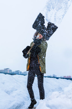 Handsome Man Posing During Improvised Photoshot As Holding A Photocamera in Hands During Photosession and Looking Straight to camera Over Blue Background.Vertical Shotの写真素材